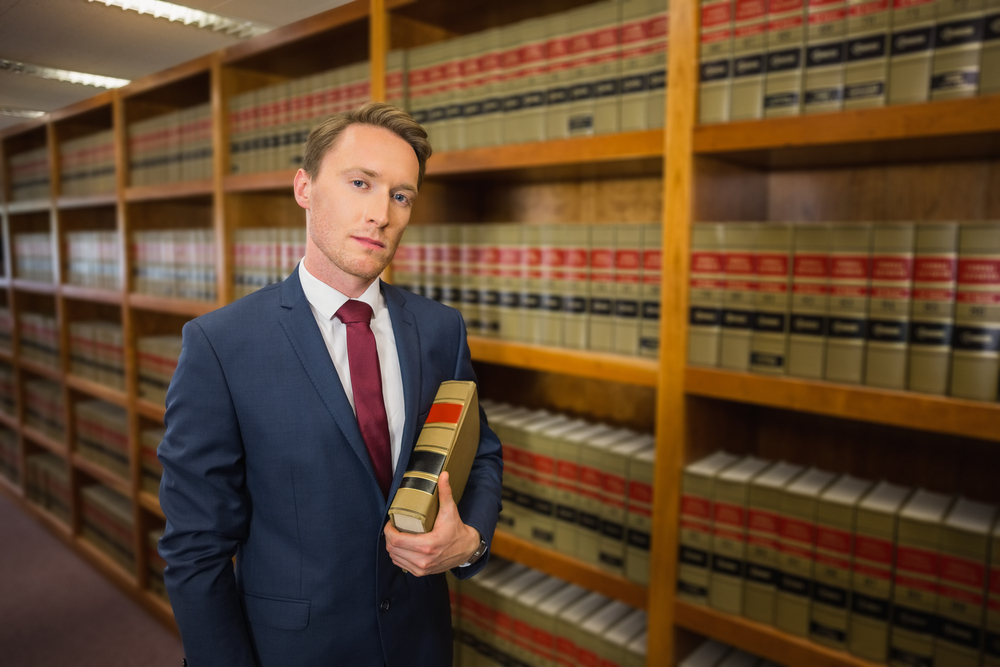 Handsome lawyer in the law library at the university Handsome lawyer in the law library at the university